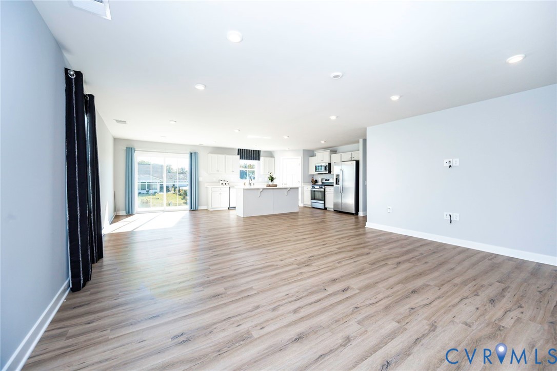 Family Room with Luxury Vinyl Flooring and Recessed Lighting