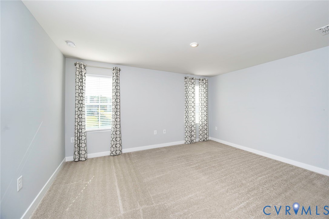 Primary Bedroom with carpeting & recessed ceiling light
