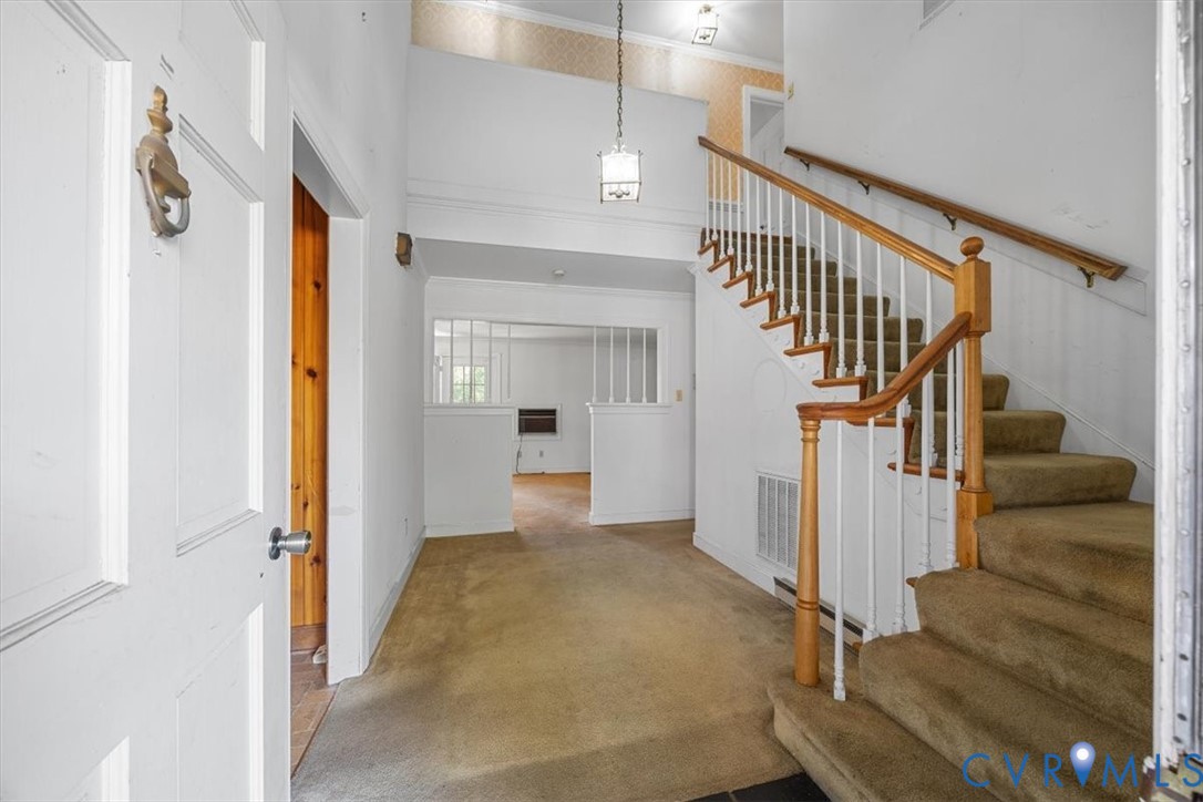 Two story foyer with staircase to second floor Two story foyer with staircase to second floor
