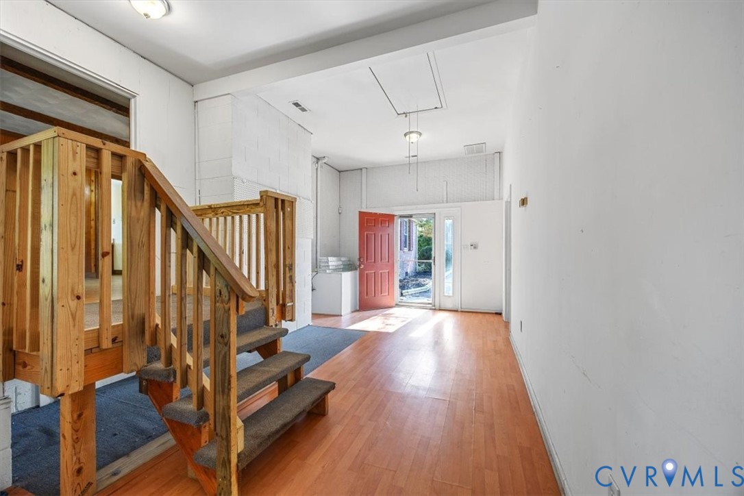Mudroom with stairs to Den and direct access to driveway