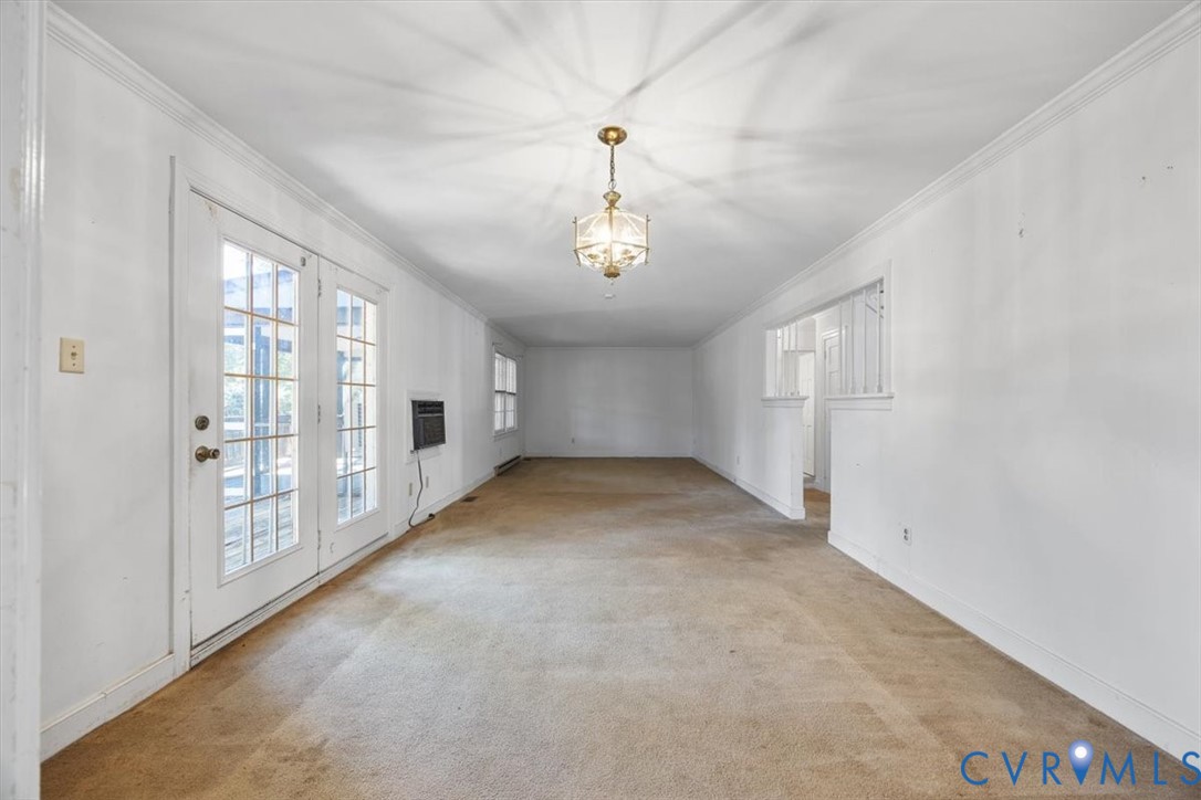 Large room for dining and living with double french doors to large deck Large room for dining and living with double french doors to large deck