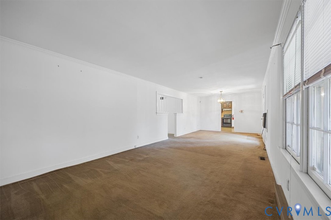 Great room for living and dining with access to foyer, pocket door to the kitchen and double french doors to large back deck Great room for living and dining with access to foyer, pocket door to the kitchen and double french doors to large back deck
