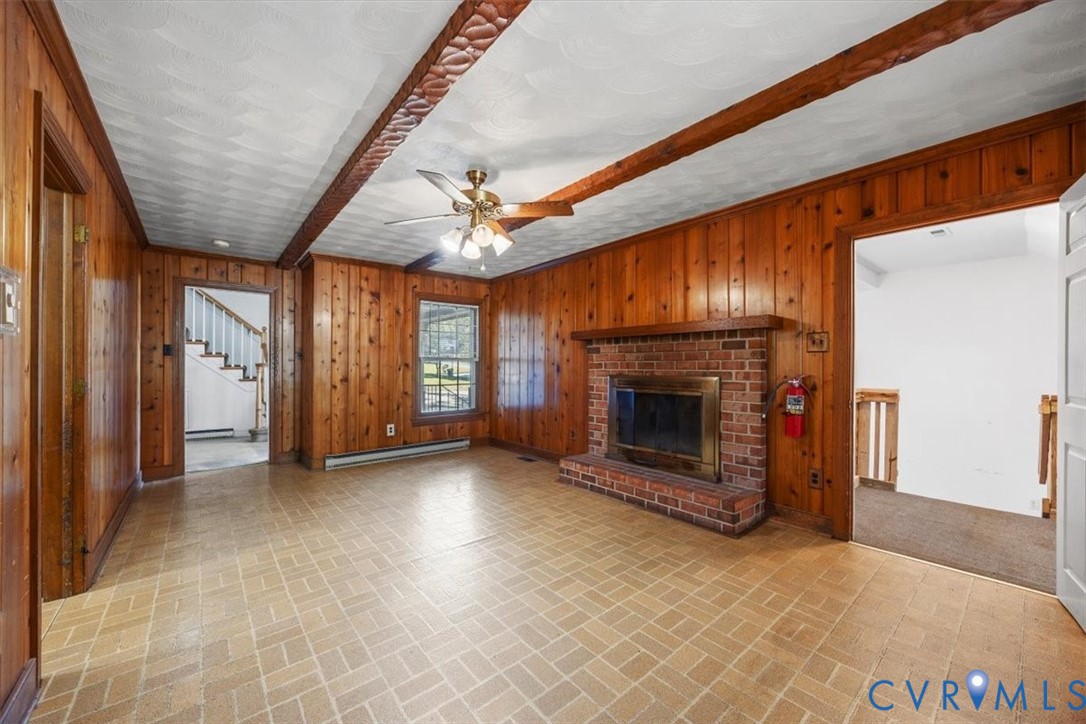 Cozy den with beamed ceiling and access to mudroom, foyer and kitchen Cozy den with beamed ceiling and access to mudroom, foyer and kitchen