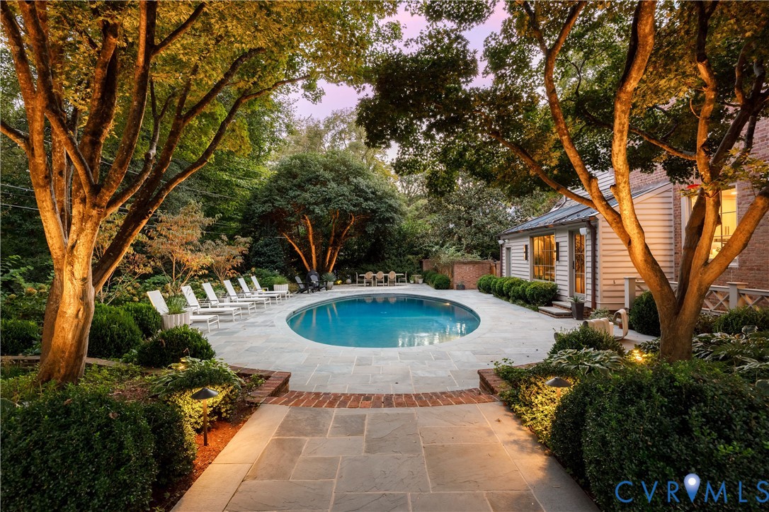 Renovated saltwater pool with a heater and chiller, set in new bluestone under new landscape lighting.