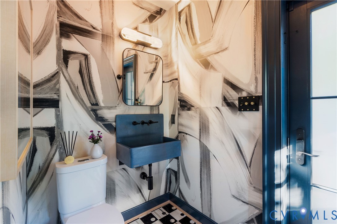 Pool bath with a custom Lindsay Cowles mural, Kelly Wearstler marble floor and towel cabinetry, with its own door to the pool.