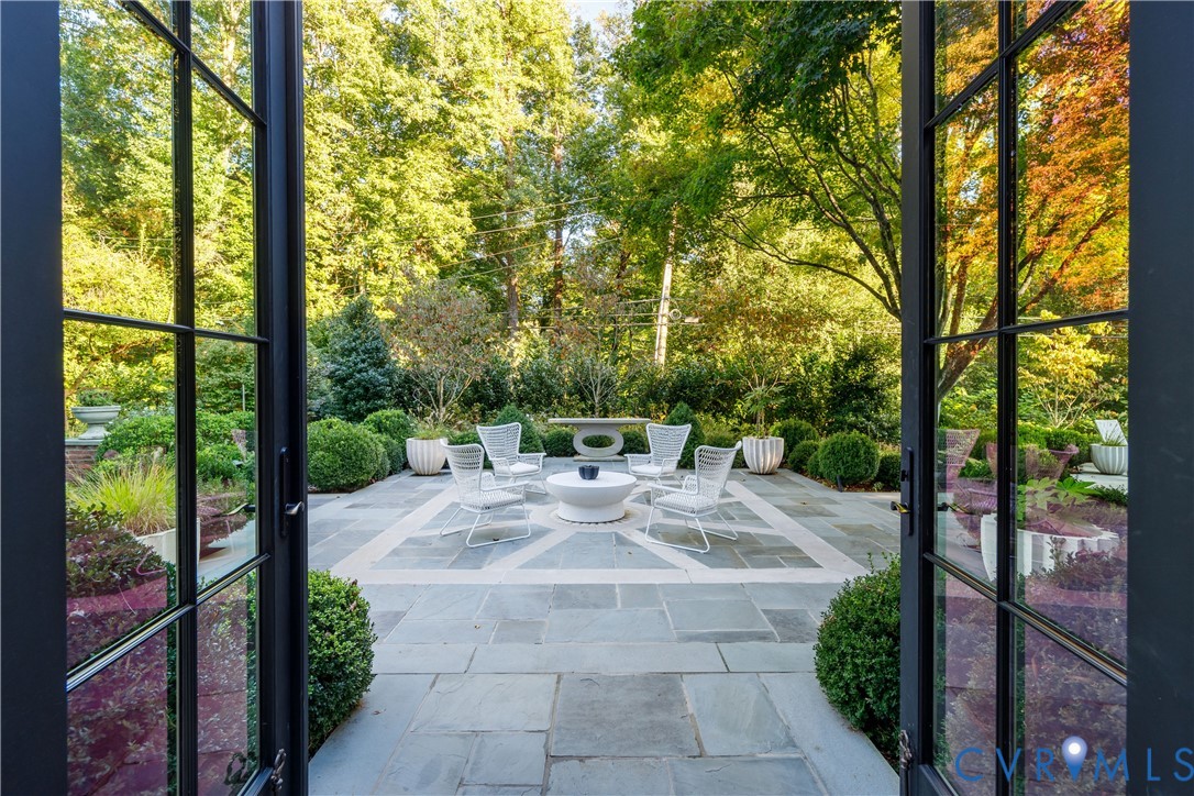 The family room opens up to the bluestone terrace with historic millstone.