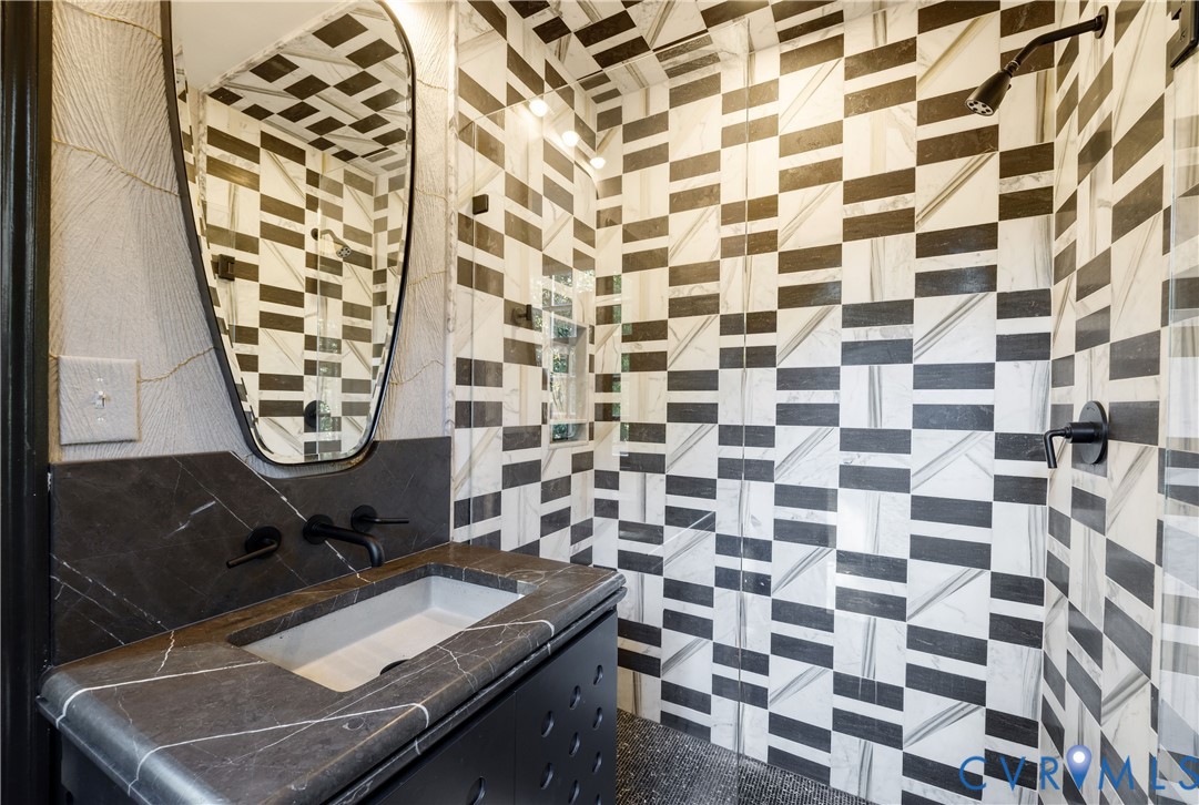 Jack-and-Jill bath with marble tile on the walls and ceiling and a heated marble floor.