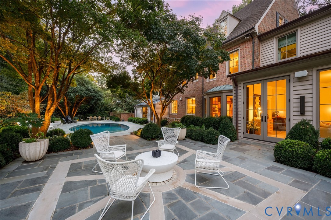 The original millstone anchors the new bluestone terrace outside the sunroom.