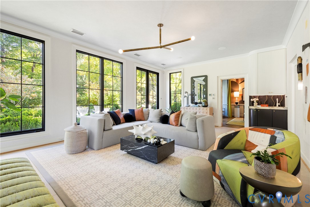 The family room's custom curved bar has an ice maker and a brass sink made in Mexico.