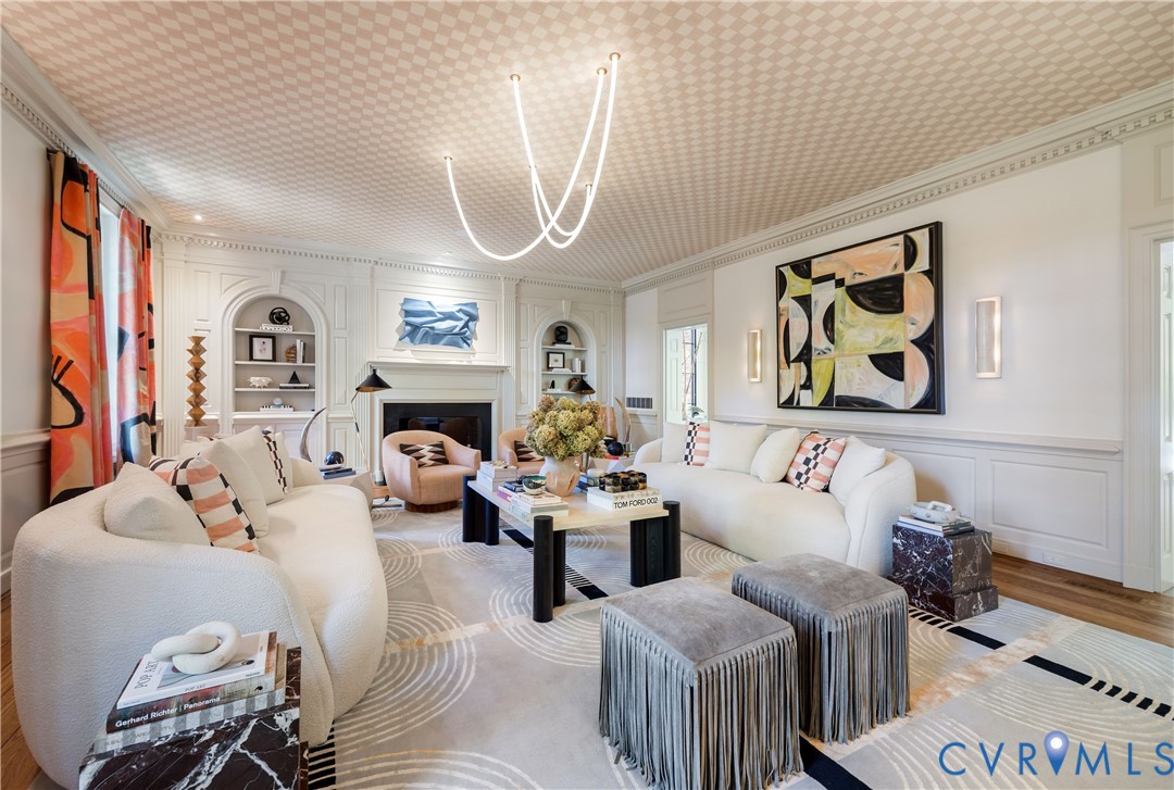 Living room with original paneling and dentil molding, a Luke Lamp Co. light, and checked grasscloth on the ceiling.