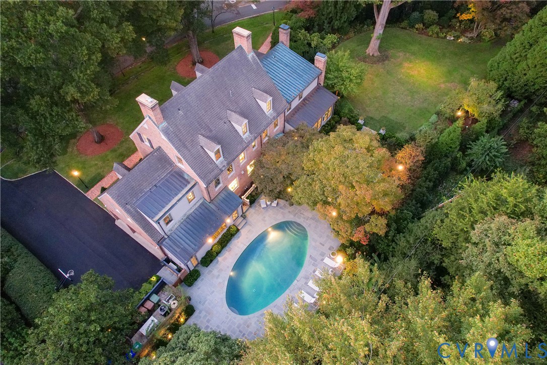 The house, 3-car garage, pool and gardens from above.