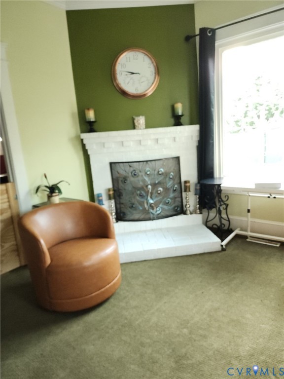 Painted brick fireplace featuring a classic mantel and hearth, large window with expansive glazing, and neutral wall tones