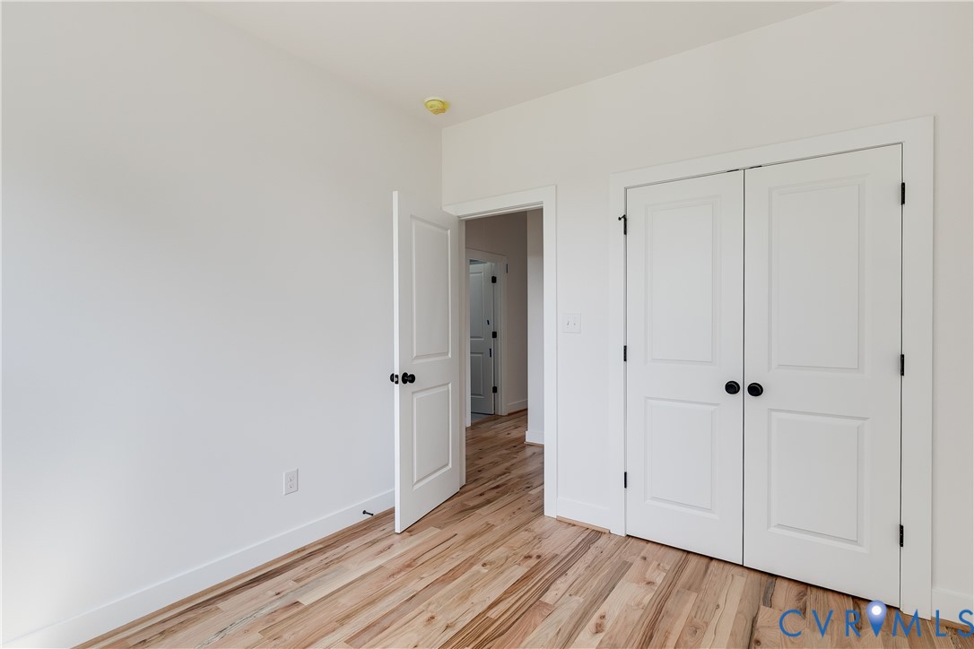 Wood-finish flooring, two-panel interior doors, and matte black door hardware