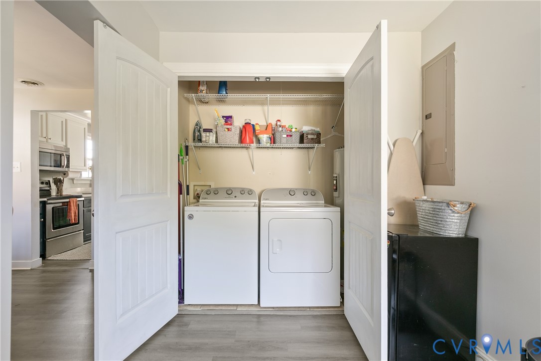 Utility area featuring double-panel doors, wire shelving, and wood-finish flooring