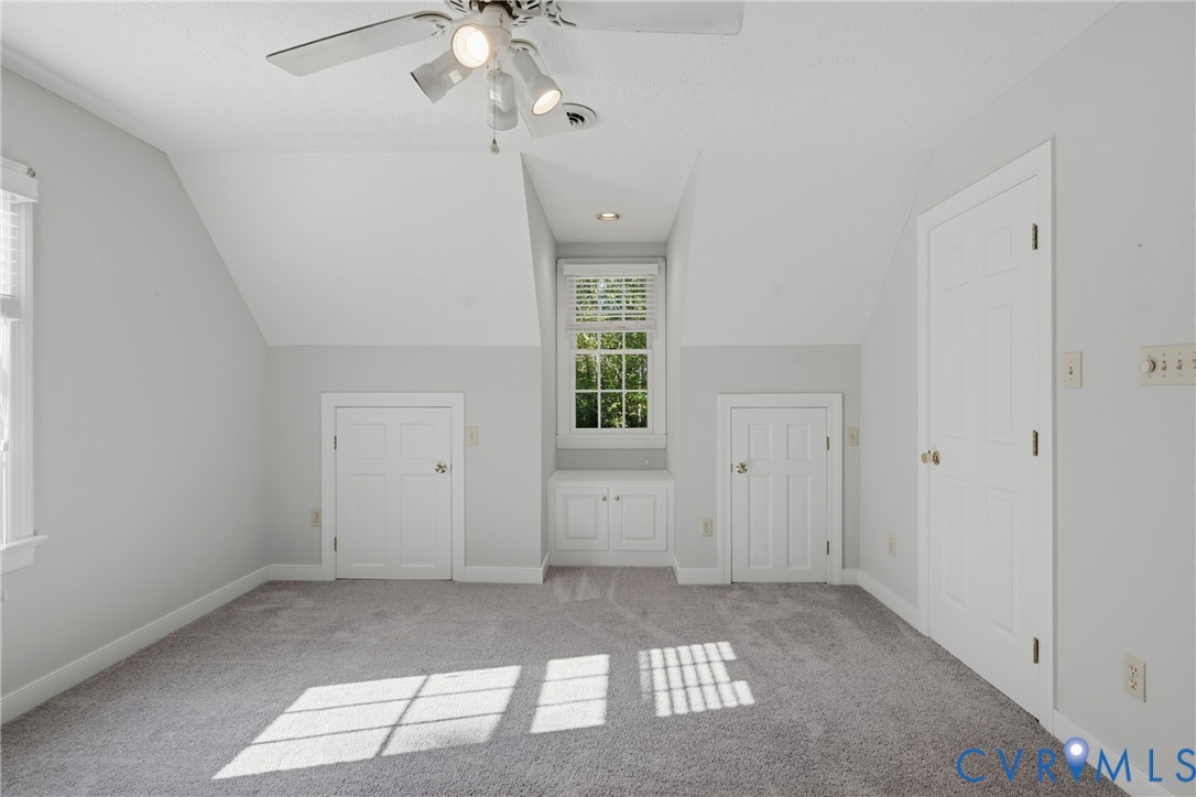 Dormer window with built-in cabinetry, recessed lighting, ceiling fan with integrated lighting, and carpeted flooring