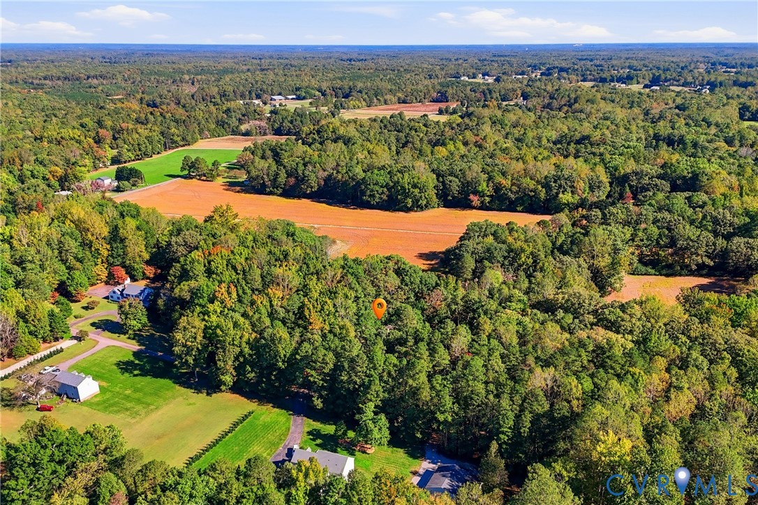 Expansive acreage featuring mature woodlands, cleared open fields, and established green space