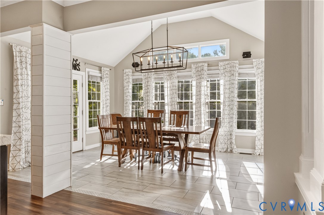 Morning Room with access to both decks and updated light fixtures and tile flooring.