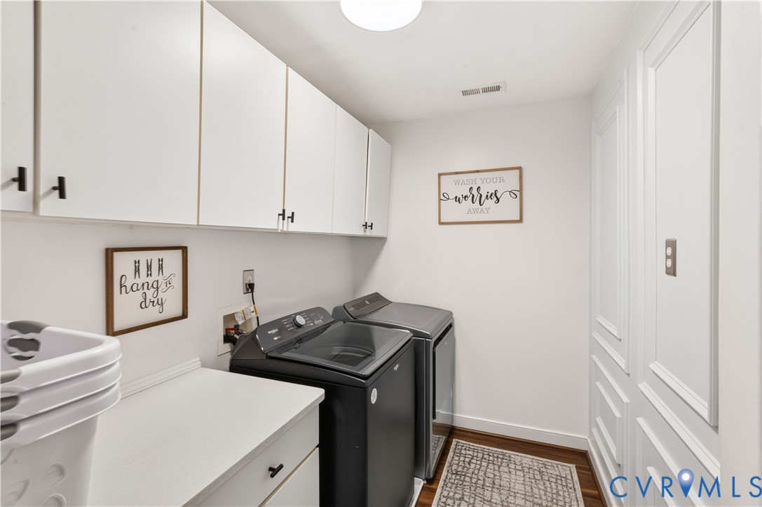 Second floor utility room. Freshly painted, new wainscoting accent wall, lots of cabinets and countertop space.