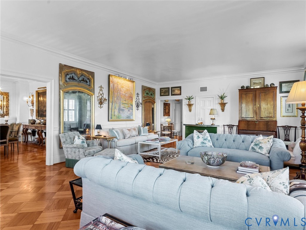 Parquet wood-finish flooring, extensive wall moldings, and built-in decorative wall mirrors