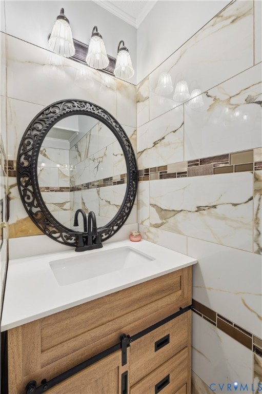 Vanity with wood-finish cabinetry, white countertop, matte black hardware, decorative oval wall mirror, and large-format wall tile with glass mosaic accent detailing