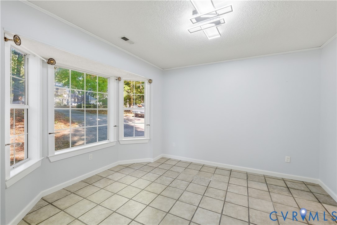 Bay window featuring multi-pane glass, tile flooring, and geometric flush-mount lighting