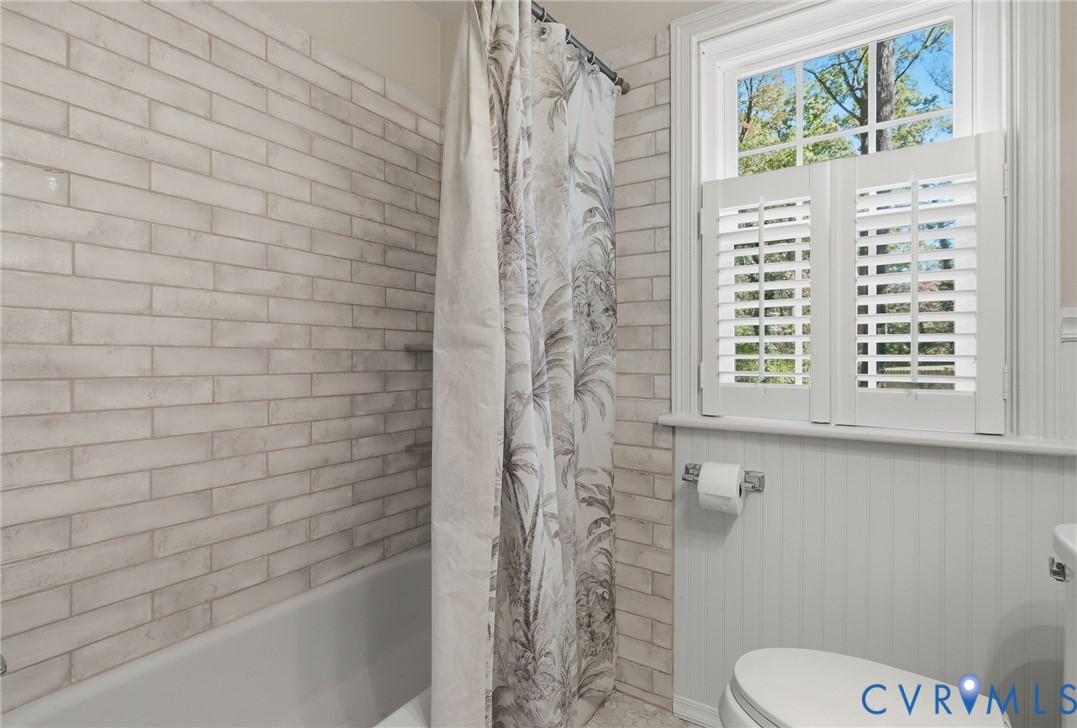 Tiled shower in hall bath