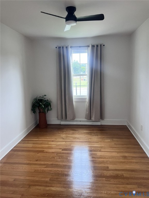 Hardwood flooring, single-hung window, and modern matte black ceiling fan