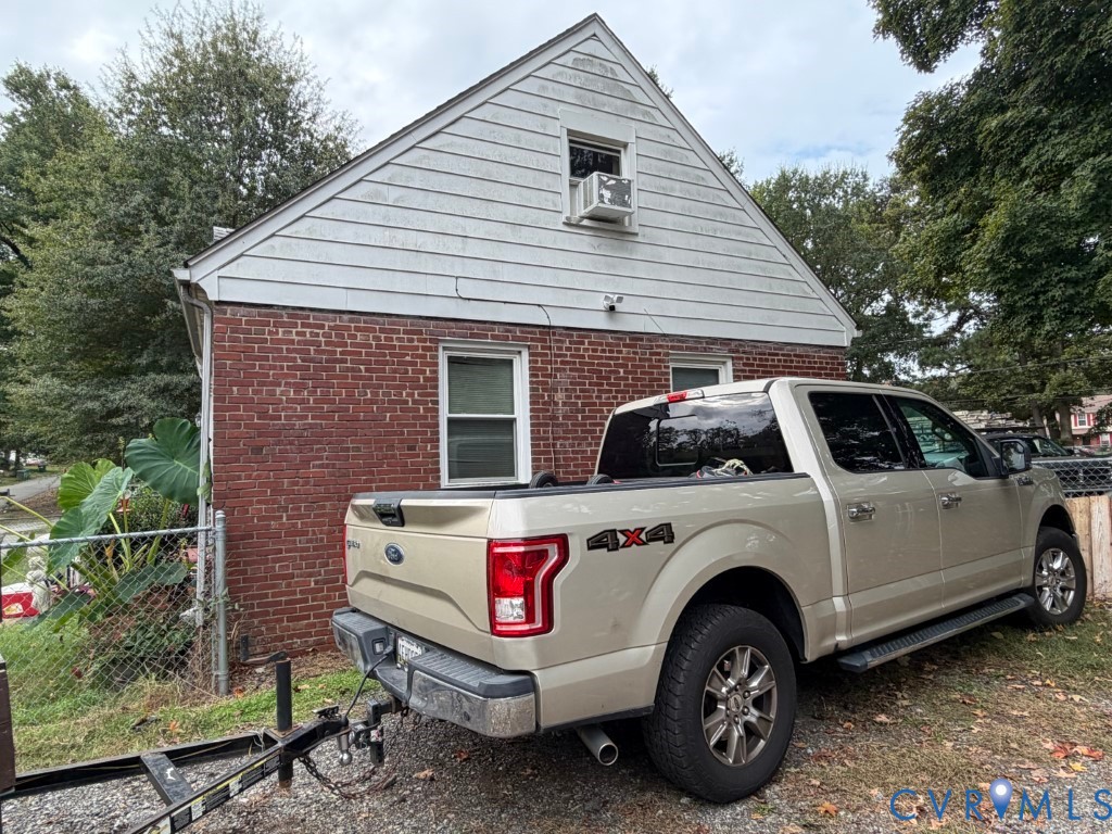 Gable-roof exterior featuring brick masonry and horizontal siding