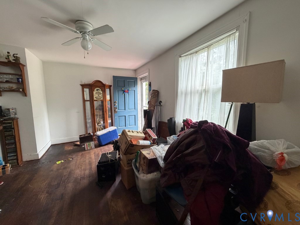 Hardwood flooring, multi-pane window, ceiling fan with integrated lighting, and blue-painted exterior door
