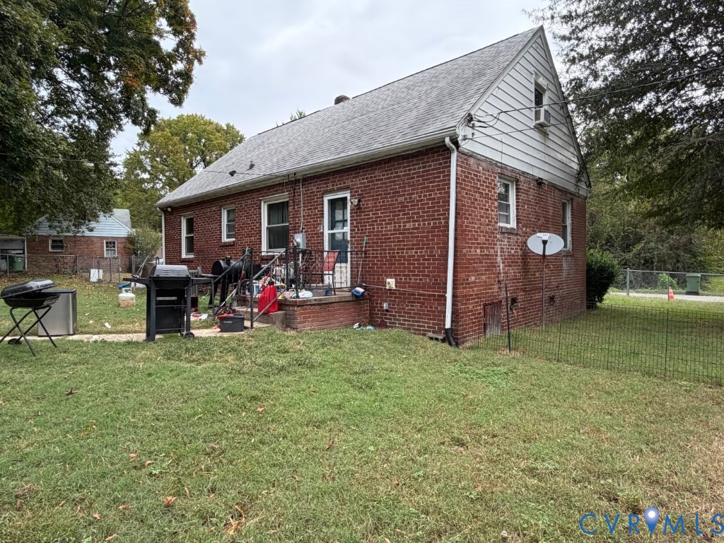 Exterior featuring red brick siding, a gabled roofline, and a masonry stoop
