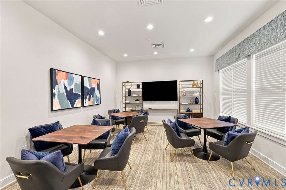 Interior space featuring recessed lighting, patterned carpeting, and horizontal window blinds