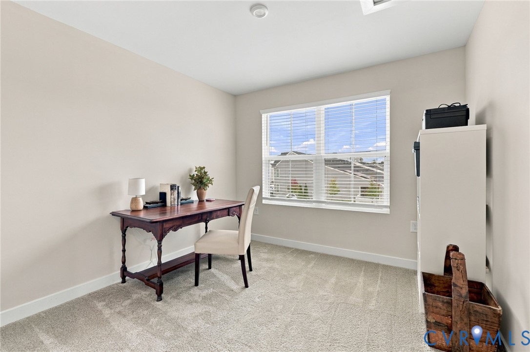 Neutral-toned wall paint, neutral carpeting, recessed ceiling lighting, and a multi-pane window with horizontal blinds