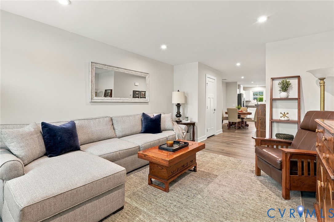 Living area featuring wood-finish flooring, recessed lighting, and a neutral color palette
