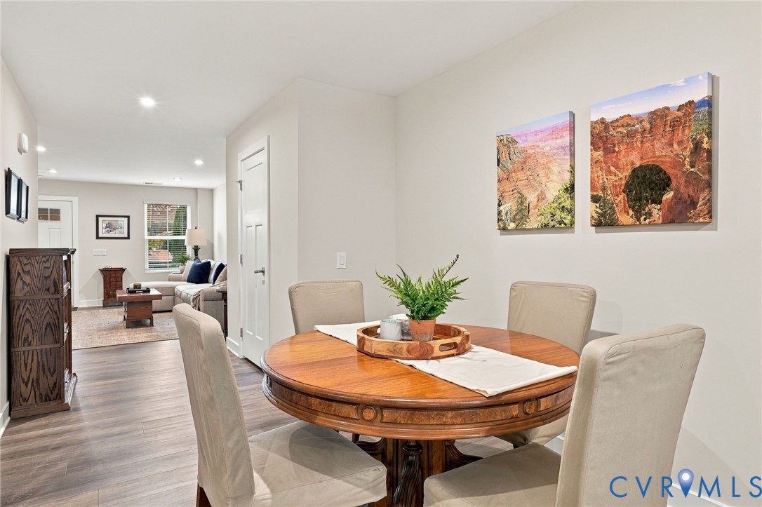 Neutral-toned interior space featuring wood-finish flooring and recessed lighting