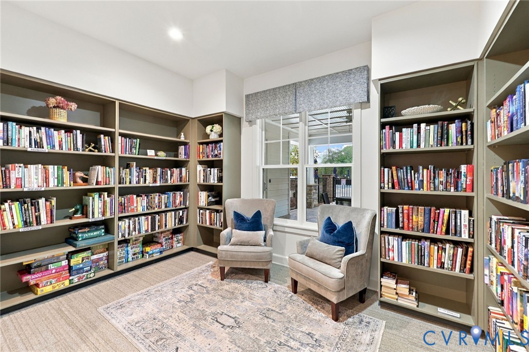 Floor-to-ceiling built-in shelving, custom cabinetry with integrated storage, dual-pane window with mullions, and recessed lighting