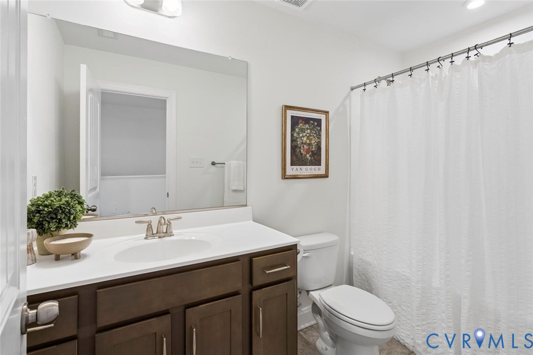 Neutral, sleek, and generous sized hall bathroom.