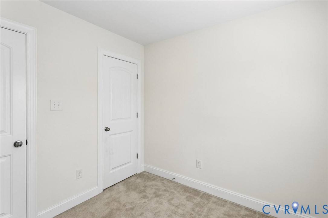 Neutral wall paint, white trim, and light carpet flooring.