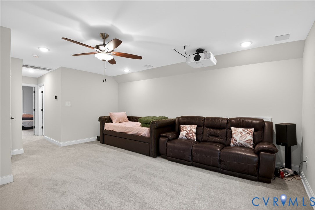 Neutral wall palette featuring recessed lighting, a ceiling-mounted fan with integrated light, and a ceiling-mounted projector