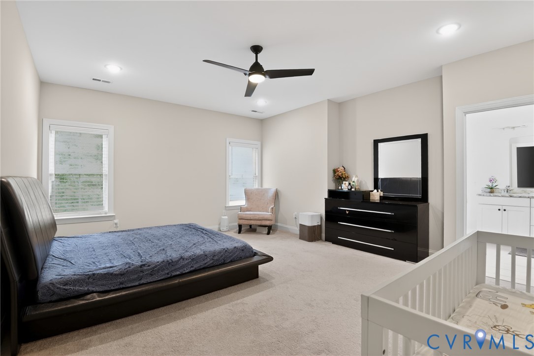 Neutral-toned room featuring recessed lighting, a multi-blade ceiling fan, and carpeted flooring