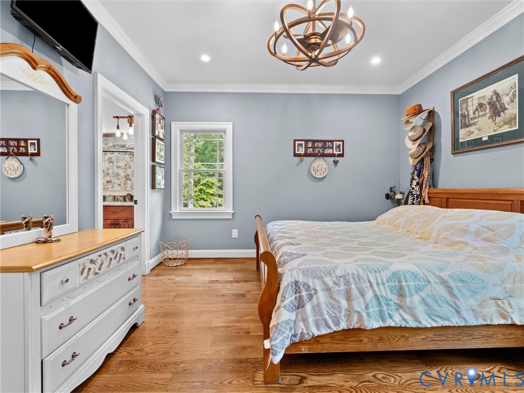 The spacious first-level primary suite offers the convenience of main-floor living, featuring beautiful hardwood floors, two closets, and a private en-suite bath. A comfortable and inviting retreat!