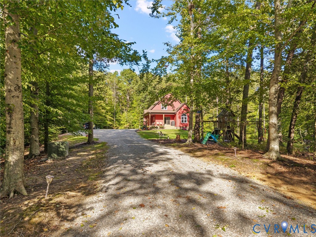 A picturesque, tree-lined driveway winds through the property, offering a peaceful approach to The Little Red Homestead. Surrounded by mature hardwoods and beautiful natural scenery, every arrival feels like a welcome escape to the countryside!