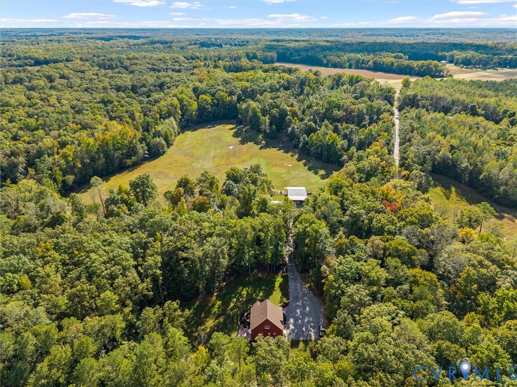 Experience the beauty of The Little Red Homestead from above! This stunning aerial view captures the property's expansive rolling pastures, mature woodlands, and peaceful countryside setting. With approximately 26.7 acres to explore, there's plenty of room for horseback riding, outdoor recreation, and enjoying the privacy and tranquility of country living!