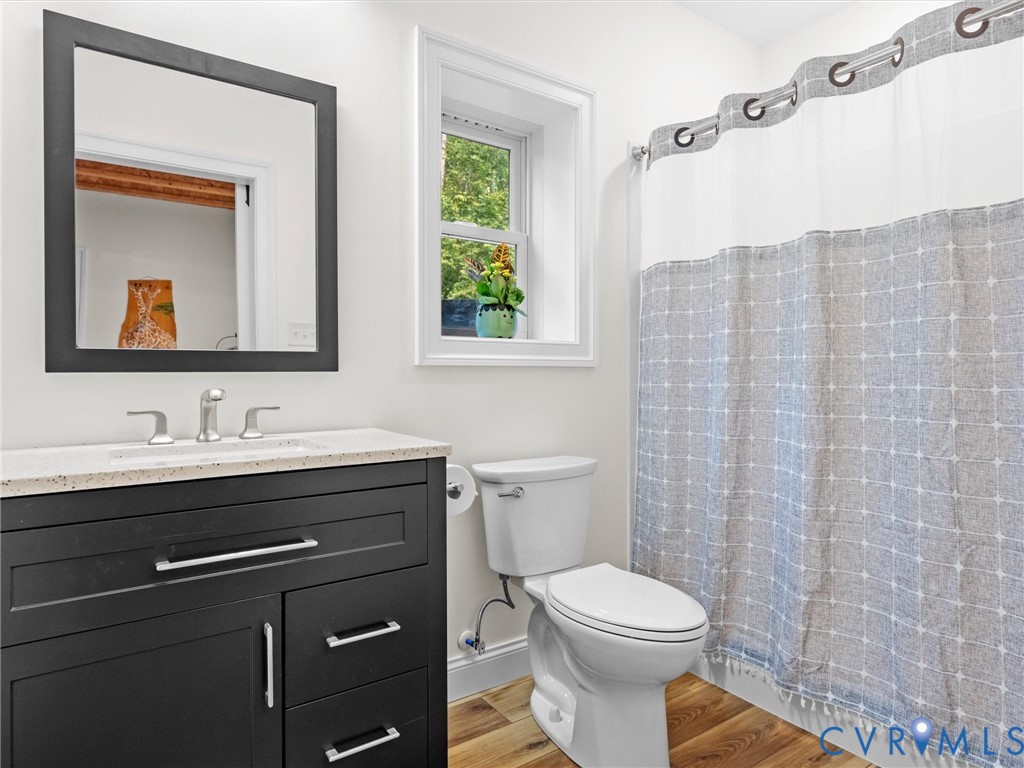 The fully finished basement bathroom features a spacious shower, stylish vanity, and natural light, offering added convenience for guests and activities on the lower level!