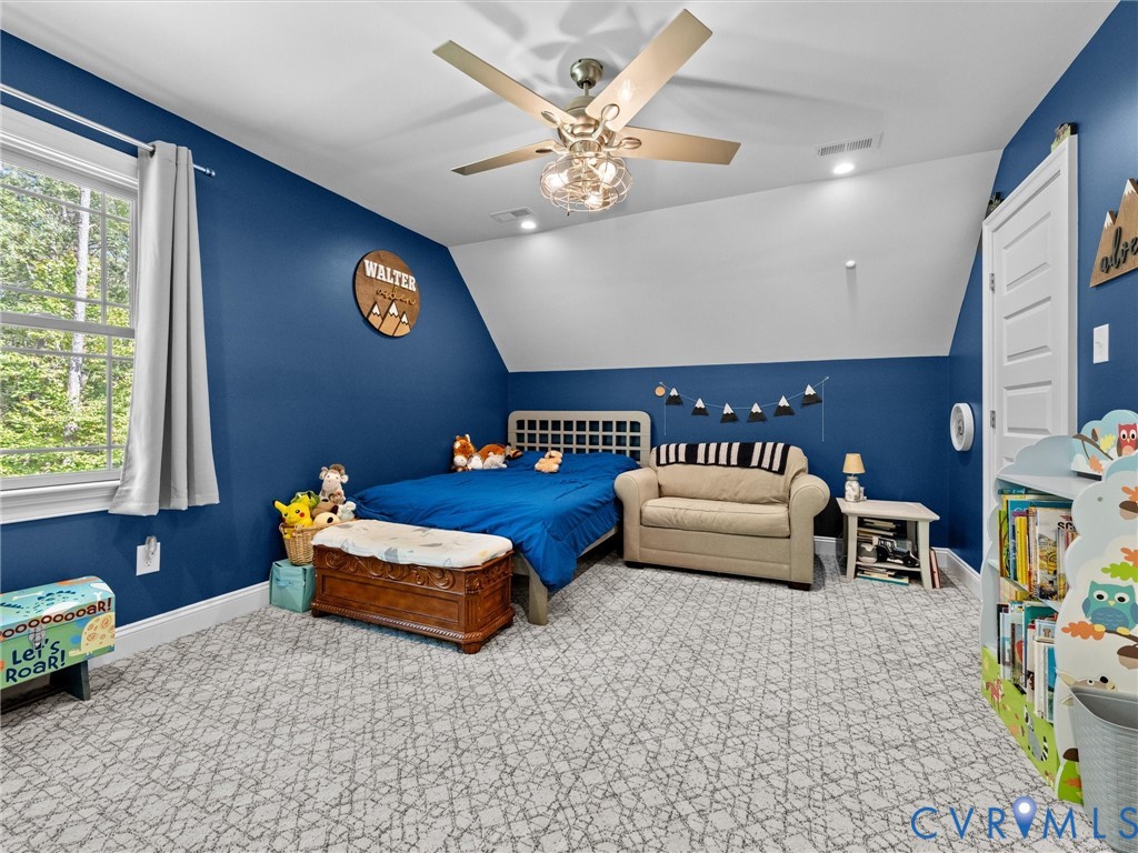 Spacious second-level Bedroom 3 features two walk-in closets, plush carpeting, a lighted ceiling fan, and two windows providing abundant natural light. A comfortable and inviting space with plenty of storage!