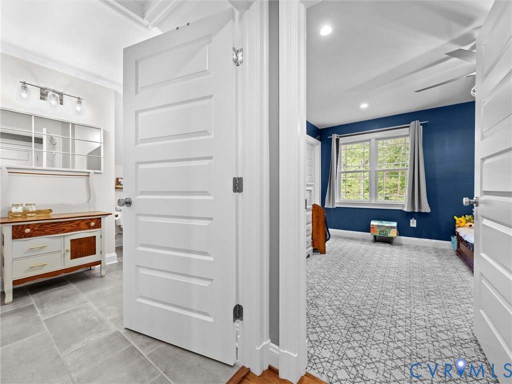 View from the upper-level hallway showcasing the spacious full hall bath, Bedroom 3, and a convenient hall linen closet. A thoughtfully designed layout offering comfort, functionality, and additional storage!