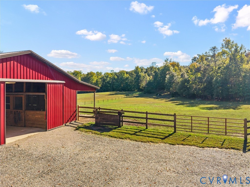 Beautiful fenced pastures with convenient access to the charming red horse barn provide an ideal setup for your equestrian lifestyle! Enjoy the ease of caring for your horses while taking in the scenic views of rolling green fields, mature trees, and the peaceful countryside surrounding The Little Red Homestead.