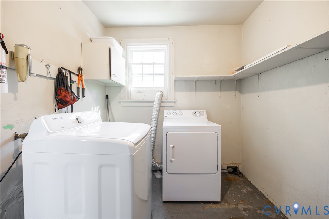 Utility room featuring a single-hung window, built-in wall shelving, and wall-mounted storage hardware