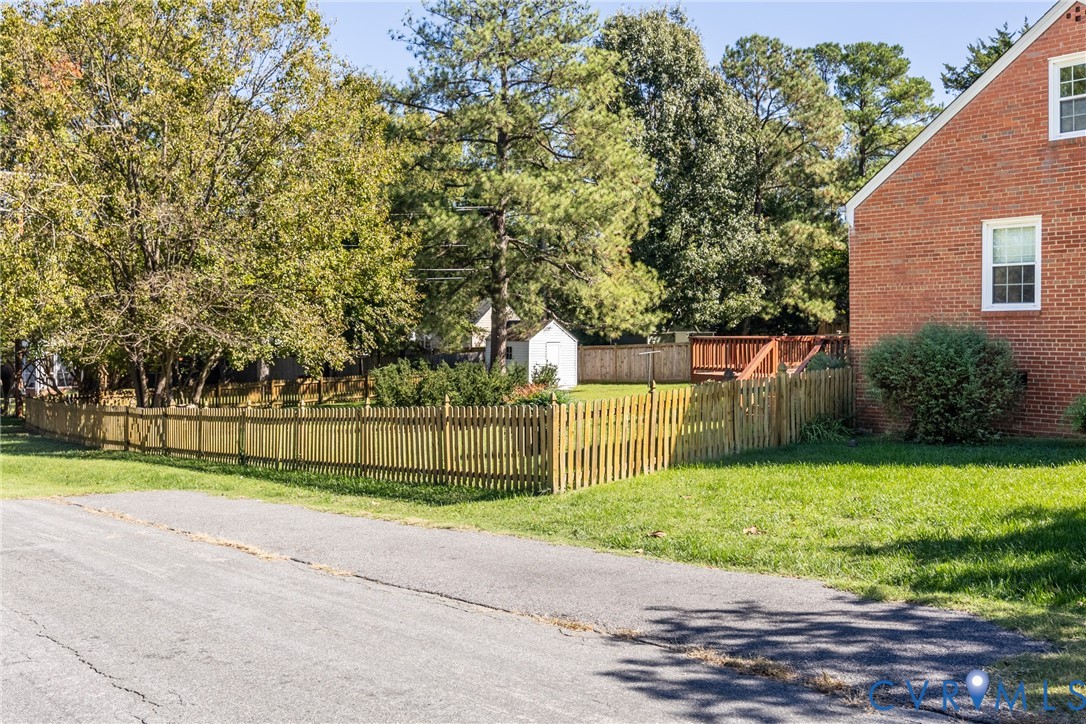 Dedicated off street parking and view of fenced in backyard from Stillwell Rd