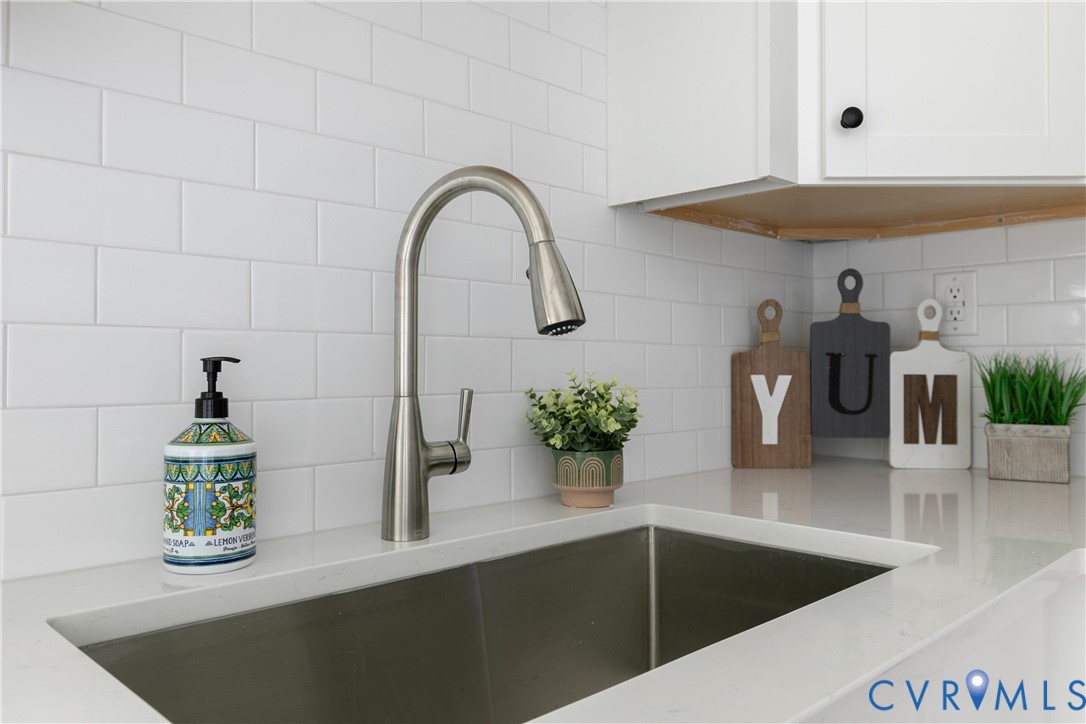 Stainless steel single-basin sink with a gooseneck pull-down faucet