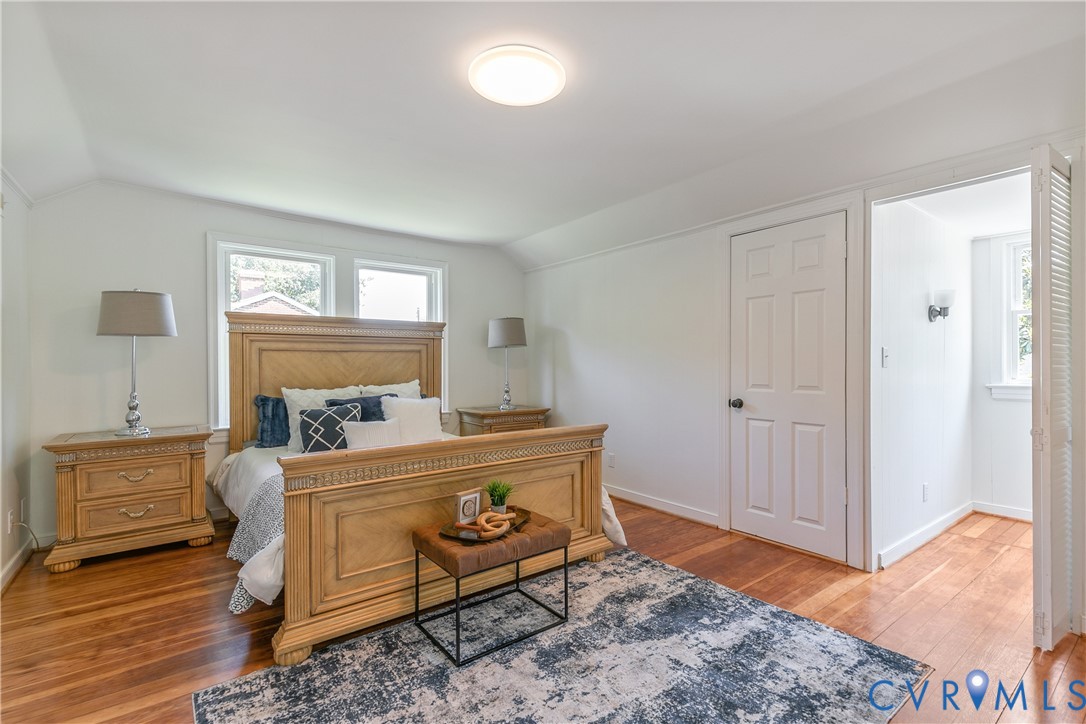 Hardwood flooring throughout, white baseboards, and bright white walls
